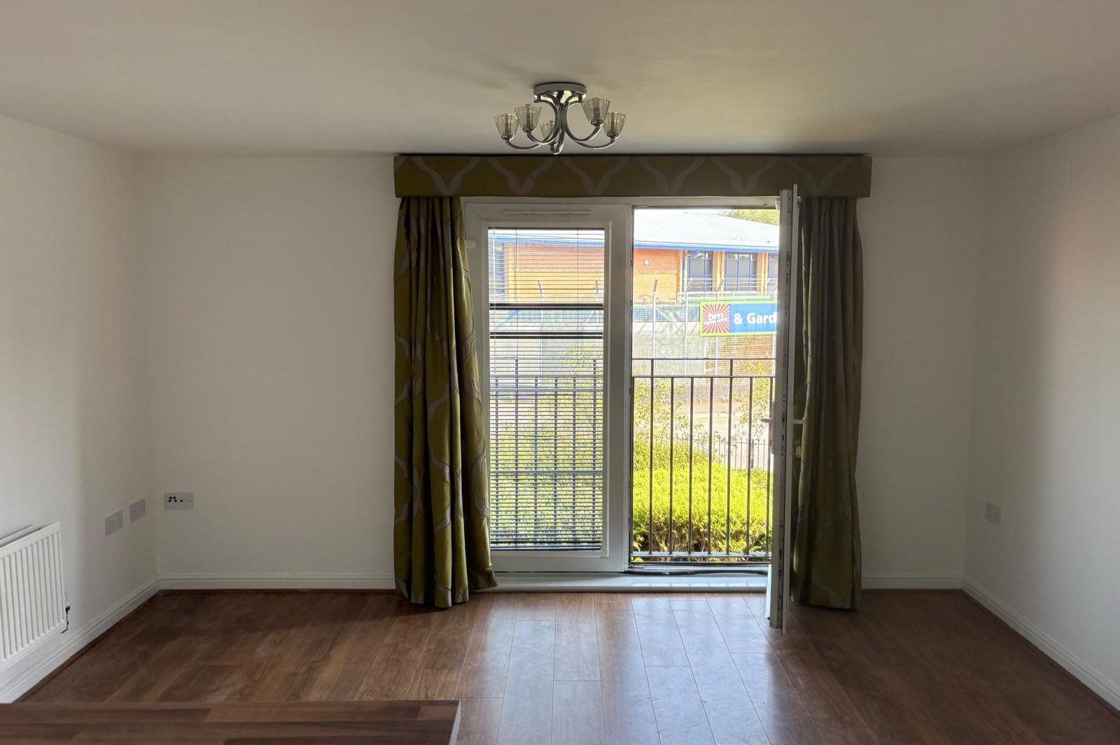 Living area of the completed residential flat with balcony doors